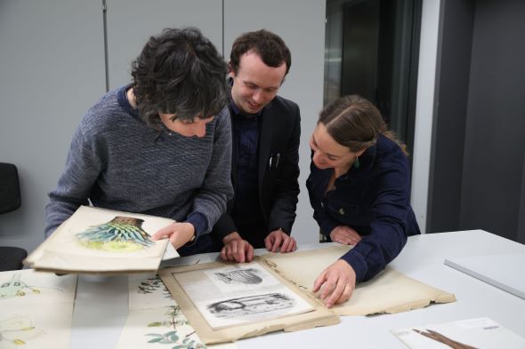 Herbarium staff with specimens collected by Charles Darwin