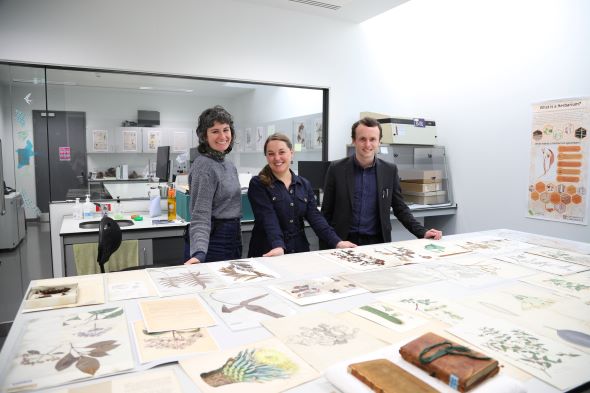 Herbarium staff with specimens collected by Charles Darwin